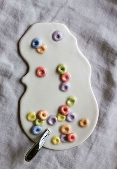 a white plate topped with doughnuts and a pair of scissors