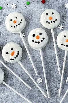 frosted marshmallows with snowman faces on them