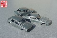 three toy cars sitting on top of a gray floor next to each other and one is missing the hood