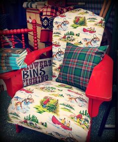 a chair that is sitting in front of a pile of books and other items on the floor