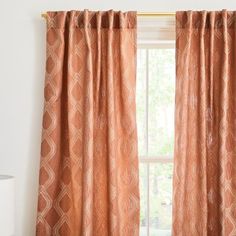 an orange curtain hanging in front of a window