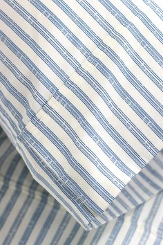 the blue and white striped shirt is folded up to show it's pattern on the collar