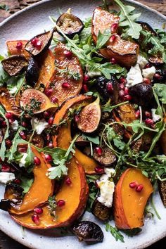 a white plate topped with sliced up peaches and greens