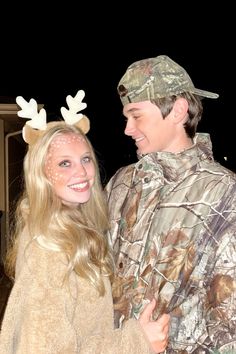 a man and woman wearing deer antlers on their heads