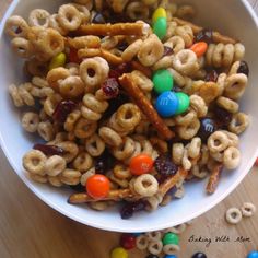 a white bowl filled with cereal and m & m candies