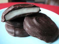 three chocolate covered cookies on a blue plate