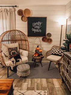 a living room with wicker furniture and decor on the walls, including a rattan swing chair