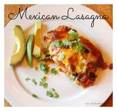 mexican lasagna on a white plate with avocado