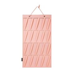 a pink door hanging on a wall