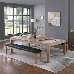 a dining room table with two benches and a bench in front of the window,