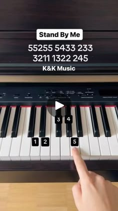 a person is playing the piano with their finger and fingers pointing at it, which are labeled stand by me