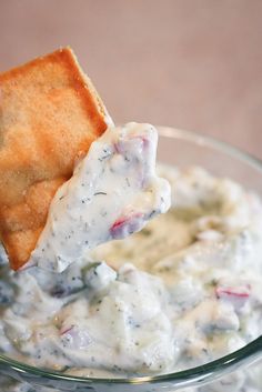 a glass bowl filled with dip and chips