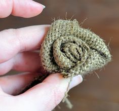 someone is holding a tiny crocheted object in their left hand and it looks like a snail