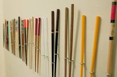 a row of baseball bats hanging on a wall