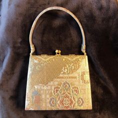 Vintage Japanese, Elegant Gold, Top-handle Party Handbag for kimono, made of obi brocade, Lace like metal part motif 030048   Color on photo no.1 is the closest to the real one. This bag is smaller, so good as an accessory as well.   The metal part around the clasp is a very elegant lace-like motif with some shining tiny pieces of glass. The clasp is shaped acorn, very cute. You would look elegant with this bag because of the chic motif and the way you hold it.   Please appreciate the Japanese elegance and chicness having this bag in your hands. width   bottom 19cm(7.48in),  top 16.8cm(6.61in)  height  16cm (6.3in) depth   4.8cm (1.89in) height of handle 13cm (5.12in)  Good condition Vintage No special smell. No remarkable damage, stain, color fading.   The metal clasp part is in good cond Japanese Handbag, Sewing Projects Clothes, Party Handbags, Japanese Gifts, Obi Belt, Vintage Heels, Vintage Makeup, Top Handle Bags, Vintage Kimono