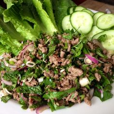 lettuce, cucumber and meat salad on a white plate