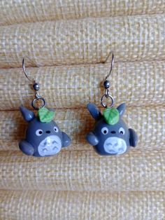 a pair of animal shaped earrings sitting on top of a table