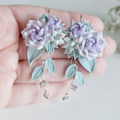 Bridal peony earrings. Handmade polymer clay peony flowers earrings. Romantic wedding dangle earrings. Lavender purple peony with mint succulent, crystal beads and mint leaves earrings. Wedding gift. Polymer clay artisan jewelry with mint succulent pastel lilack peony rose is made by myself from polymer clay. Mint and purple wedding blossom earrings.The length of earrings 5,8 cm( 2 14 in)The width 3 cm ( apx 1 18 in)The weight of one earring approx. 3,5gOur jewelry needs careful handling. Earrin Handmade Flower Dangle Earrings In Polymer Clay, Handmade Flower Dangle Jewelry In Polymer Clay, Wedding Earrings With 3d Flowers In Polymer Clay, Wedding Polymer Clay Flower Dangle Earrings, Polymer Clay Flower Drop Earrings For Wedding, Wedding Flower Drop Earrings In Polymer Clay, Flower-shaped Polymer Clay Wedding Earrings, Handmade Flower Polymer Clay Wedding Earrings, Wedding Flower Earrings With 3d Polymer Clay Flowers