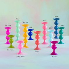 a group of colorful candles sitting on top of a white table next to each other