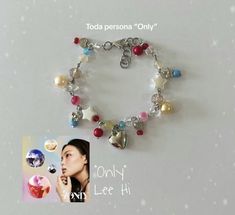 a bracelet with charms on it and a photo of a woman's face in the background