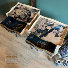 two blue and white vases sitting on top of a wooden floor next to paintings