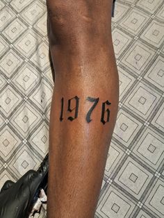 a man with a tattoo on his leg that has the number seventy written on it