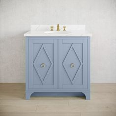 a white sink sitting next to a blue cabinet on top of a hard wood floor