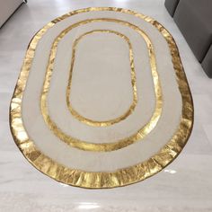 a white and gold rug on the floor