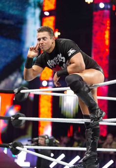 a man standing on top of a wrestling ring