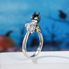 a cat ring sitting on top of a white table next to a blue wall and water