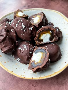 a white plate topped with chocolate covered donuts