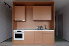 a kitchen with an oven, sink and cabinets in the room that is painted orange