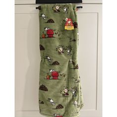 an oven mitt hanging on the wall with sheep and farm animals printed on it