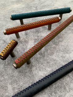 three different types of pens sitting on top of a gray carpeted floor next to each other