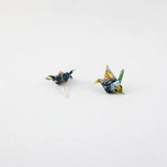 two small blue and yellow birds sitting next to each other