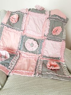 a pink and gray blanket sitting on top of a chair