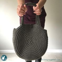 a woman is holding a purse made out of chains