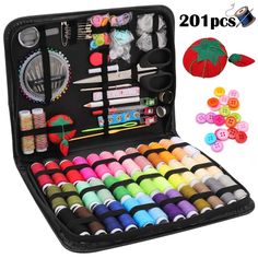 an open case filled with lots of crafting supplies and thread, scissors, buttons