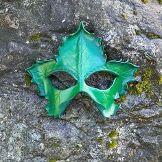 This little leather leaf mask would make a lovely dryad costume or elven cosplay! This woodland themed accessory is equally well suited for a ren faire costume or wall decor. MEASUREMENTS + MATERIALS ✭ Materal: tooling leather, dye, paint, sealant, and quality ribbon ties. ✭ Measures approximately 9" wide by 7.75" high at the highest and widest points ✭ Ties with gorgeous and durable stretch ribbon straps (included). The mask is sculpted from fine tooling leather. It's hand carved, and painted in cool shades of forest green and emerald. Some of the photos show this mask beside a similar orange version. This listing is for the larger green mask shown alone in the first several photos. The orange/yellow mask is available in a separate listing, and they'd work nicely together as a thematic pa Dryad Costume, Leaf Mask, Elven Cosplay, Woodland Fairy Costume, Paint Sealant, Ren Faire Costume, Half Mask, Leather Leaf, Woodland Fairy