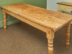 a wooden table sitting in the middle of a room