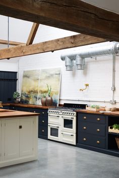 a kitchen with an oven, sink and counter tops in it's center island