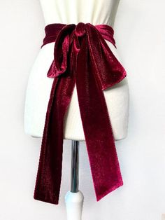 A superior quality double layer classic velvet sash, which can be tied around the waist in a number of ways. Hand sewn and has all hidden stitching.We carry several different lengths and your choice of either 4 inch width or a 2 inch width. The longer sashes can be wrapped around twice and tied in a bow, or knotted and left to dangle, to the center front, or slightly to the side. Alternately, wrap the sash once and tie a bow at the back, with long dangles.The shorter length sashes can be used fo Red Belt For Wedding Dress, Wedding Dress With Red Sash, Velvet Sash Belt, Bridesmaid Dress Floral, Orange Sash Belt, Red Waist Belt, Infinity Dress Bridesmaid, Velvet Belt, Bridesmaid Belt