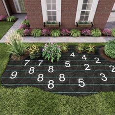 a black yard mat with numbers and plants on it in front of a brick house