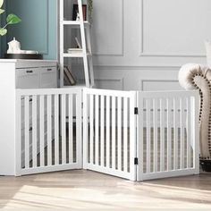 a white baby crib next to a book shelf