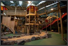 an indoor play area with rocks and climbing equipment