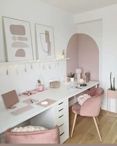 a white desk topped with pink chairs next to a wall filled with pictures and plants