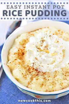 a white bowl filled with rice pudding and topped with whipped cream