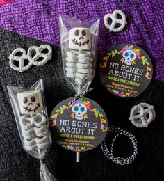 some kind of candy with skeleton decorations on it, and two lollipops in the shape of skulls