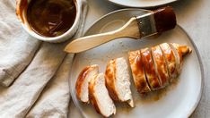 slices of sliced chicken on a plate with sauces and a spatula next to it