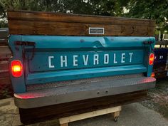 the back end of a blue chevrolet truck